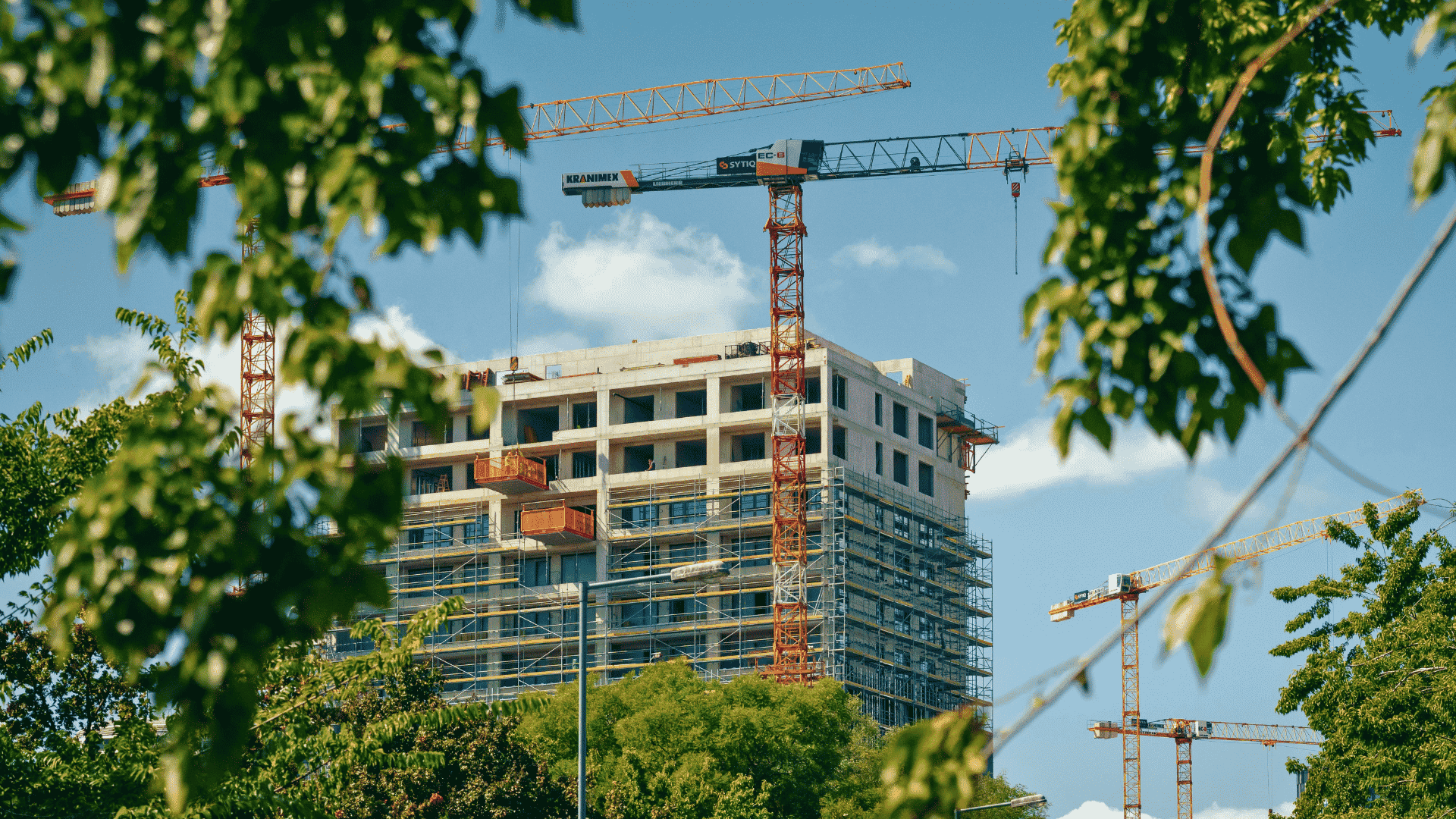 Building under construction with cranes, representing sustainable engineering and construction